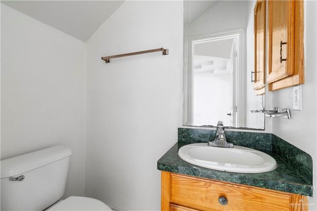 Half bath with vaulted ceiling and vanity | Image 10