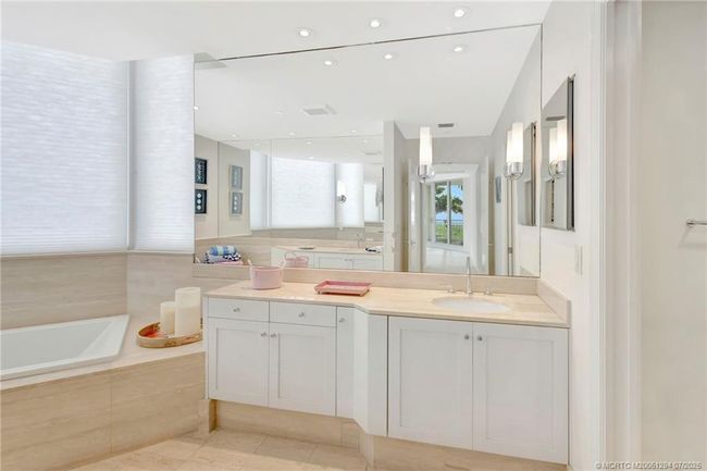 Primary bath with marble countertops and floors. | Image 25