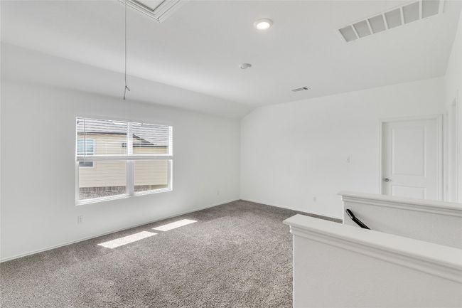 Carpeted spare room with vaulted ceiling, attic access, and recessed lighting | Image 24