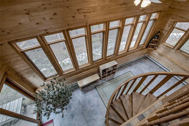 Stairway featuring plenty of natural light and wood walls | Image 22