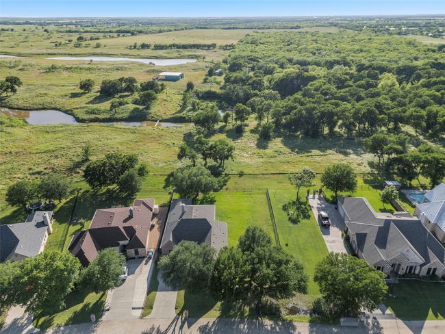 This home has no homes behind it with a beautiful greenbelt to enjoy! 3014 Preston Club Dr is in the middle of the photo showing good size lot to the right of home. | Image 37