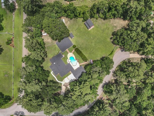 Aerial of the property with the ~1 acre behind the main ~1 acre property. Note Barn, Pool Equipment building, Bigger shed, and a small corral in the upper left portion of the photo. And the back ~1 acre entrance gate from Pin Oak Drive. | Image 50