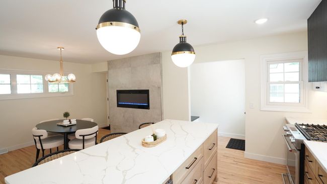 The newly added exterior door to the left of the fireplace allows for direct access into the garage. The back door area contains a newly added mudroom and leads to the backyard, the four season porch and another garage entry. | Image 7