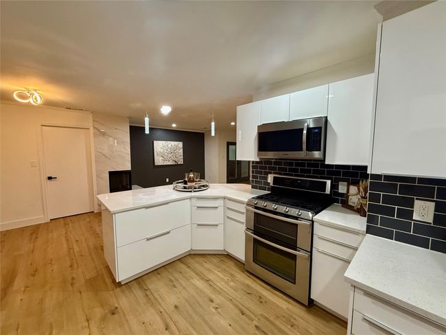 Updated cabinetry, stainless steel appliances with Quartz countertops | Image 8