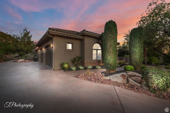 Mediterranean / spanish-style home with concrete driveway, a garage, stucco siding, stone siding, and a tile roof | Image 67
