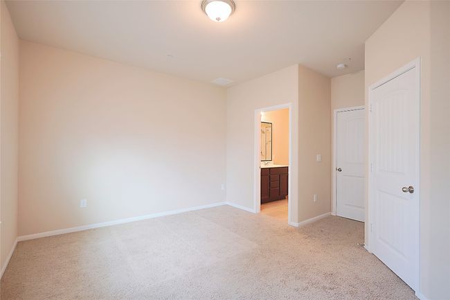 Unfurnished bedroom with light carpet and ensuite bath | Image 8