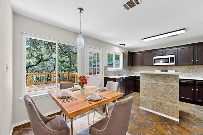 Dining area featuring dark stone finish flooring | Image 4