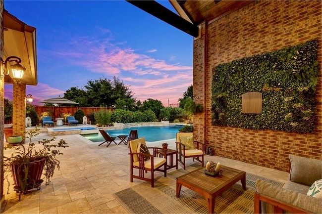 Breathtaking views of the backyard retreat and the inviting covered back porch. | Image 38