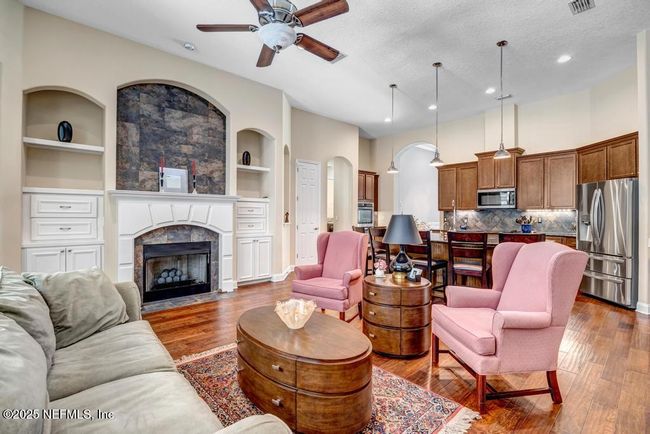 Large family room with built-in cabinets, shelving and gas fireplace | Image 4