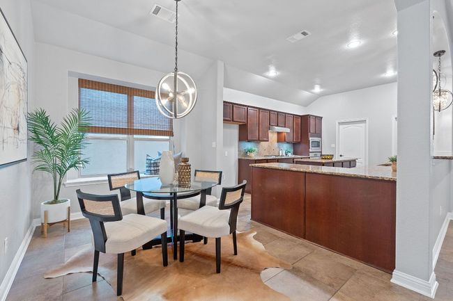 Dining room with baseboards, a chandelier, vaulted ceiling, and recessed lighting | Image 18