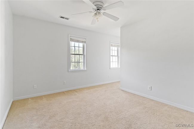 Empty room with light colored carpet and ceiling fan | Image 25