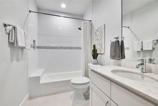 Full bath featuring vanity, shower / bath combo, tile patterned flooring, and recessed lighting | Image 9