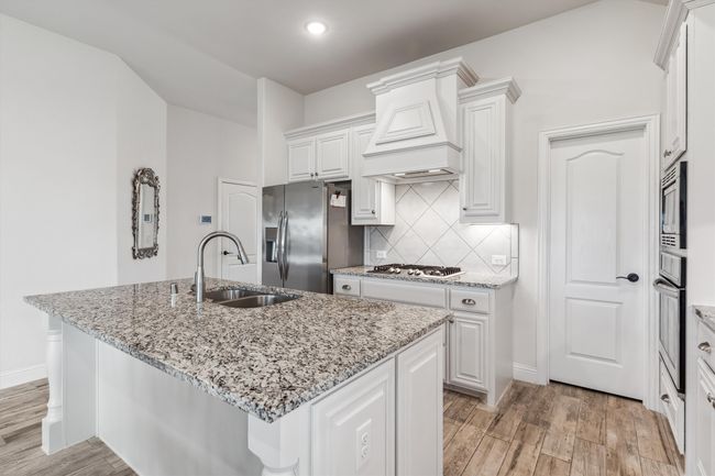 Granite countertops, ss appliances, large island, gas cooktop, and under cabinet lighting | Image 14