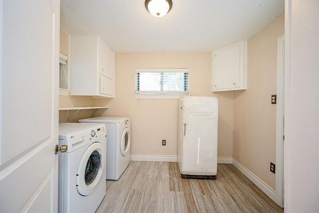 From the garage/carport, the back door leads into the laundry room. It is large enough to double as a mud room. | Image 27