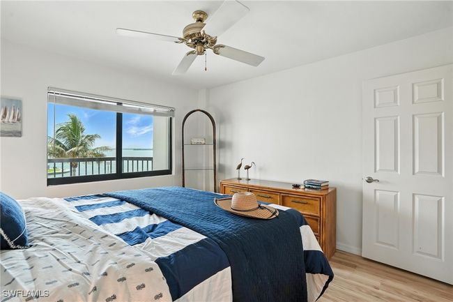 Bedroom with light wood-type flooring and a ceiling fan | Image 21