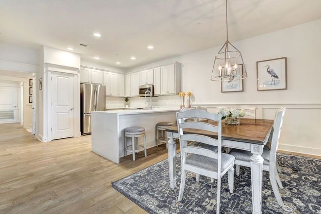 Dining area with light wood-type flooring, a chandelier, and recessed lighting | Image 11