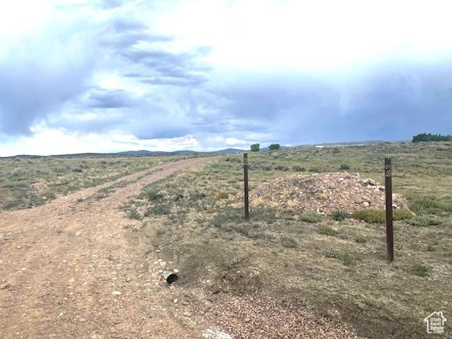 View of dirt / gravel road with a rural view | Image 6