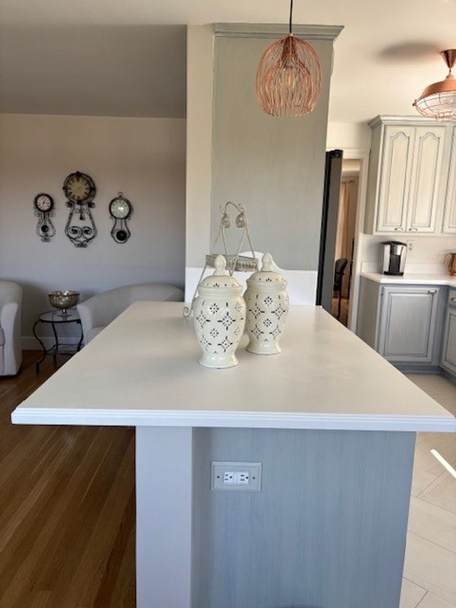 The Kitchen boasts this Large Corian topped Island w/ Lower storage cabinets | Image 19