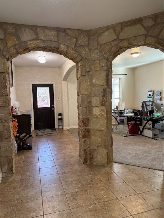 Foyer featuring arched walkways and light tile patterned floors | Image 6