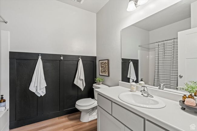 Full bathroom with light wood-style floors, vanity, and a shower with curtain | Image 10
