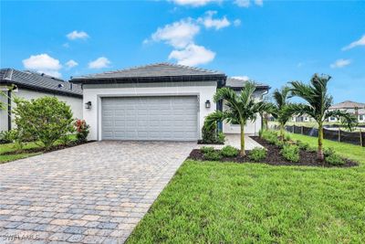 View of front of house featuring a front yard and a garage | Image 1