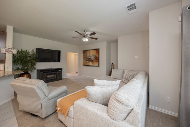 Living room featuring a ceiling fan and a fireplace | Image 12