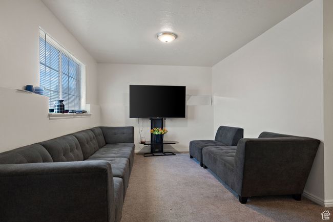 Carpeted living area featuring baseboards | Image 21