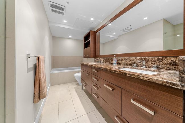 Bathroom with a bath, double vanity, tile patterned floors, and recessed lighting | Image 18