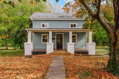 Sit on your beautiful large covered front porch and enjoy watching the seasons change. (approx 25'x9') | Image 1