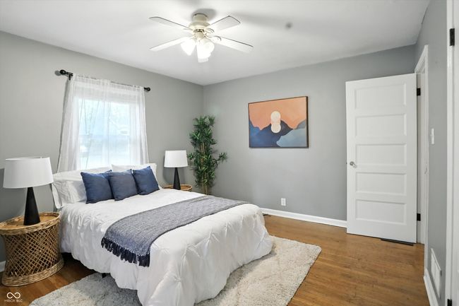 bedroom with wood finished floors and a ceiling fan | Image 24
