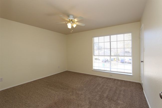 Unfurnished room featuring dark colored carpet and a ceiling fan | Image 17