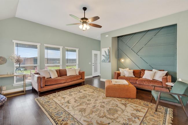 Living room featuring a ceiling fan, dark wood finished floors, and vaulted ceiling | Image 18