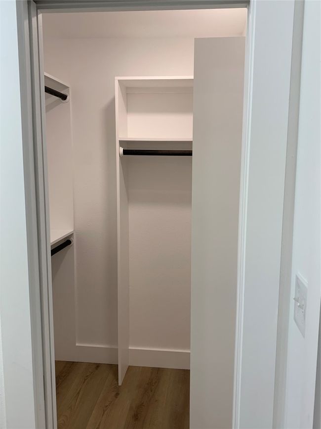 Walk in closet featuring wood finished floors | Image 13