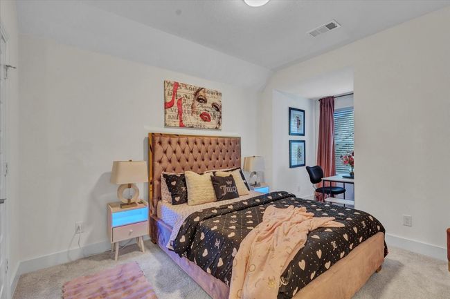 Bedroom with a study area and long window for natural lighting. | Image 28
