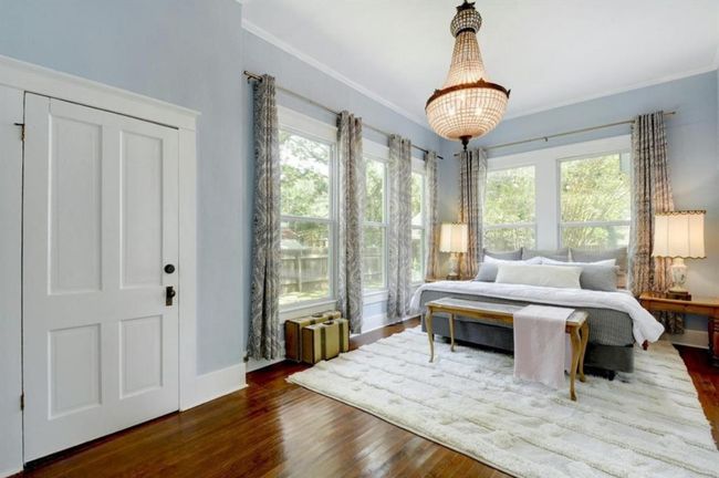 Bedroom with large windows, crown molding and wood finished floors | Image 22