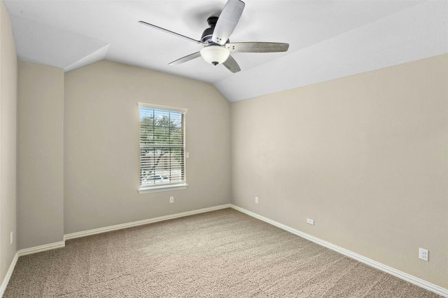 Carpeted spare room with a ceiling fan, lofted ceiling, and baseboards | Image 28