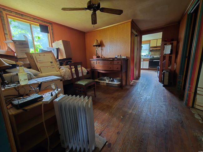 Office area with hardwood / wood-style flooring, radiator, and a ceiling fan | Image 7