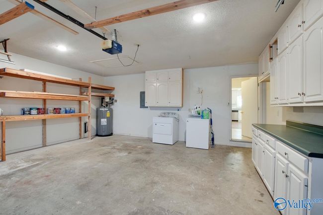 There is a washer dryer room before entering the garage. W & D stored here now. | Image 7