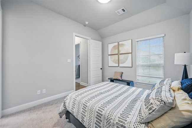 Carpeted bedroom featuring baseboards and vaulted ceiling | Image 9