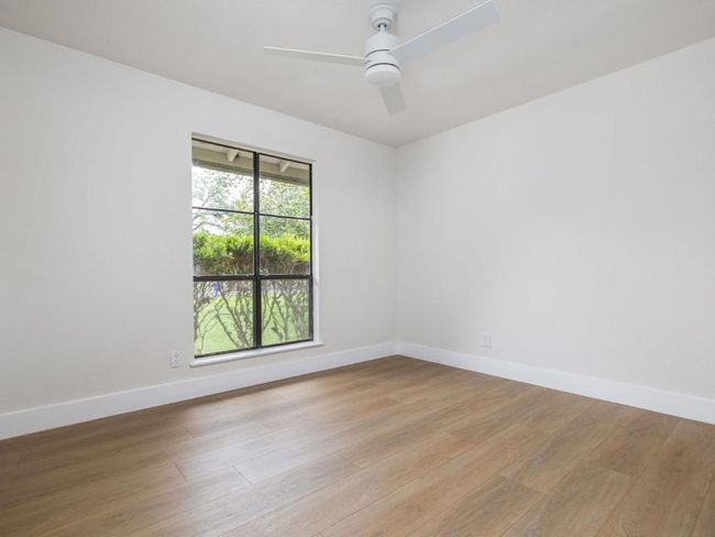 Unfurnished room with light wood-style flooring and a ceiling fan | Image 18