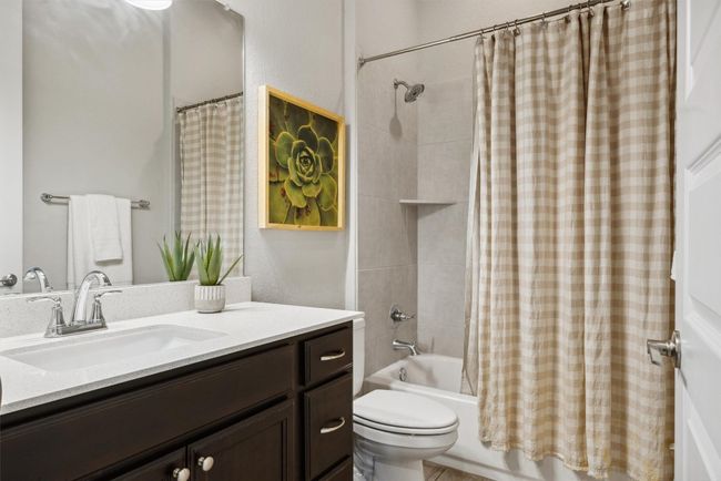 Bathroom with vanity and shower / tub combo with curtain | Image 18