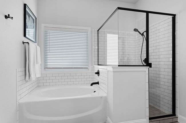 Welcome to the fresh and clean primary bath with large garden tub and separate shower | Image 29