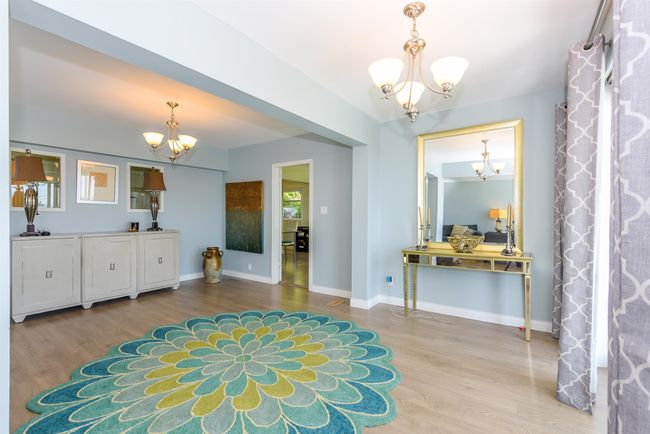 Entrance foyer featuring a chandelier, wood finished floors, and baseboards | Image 28