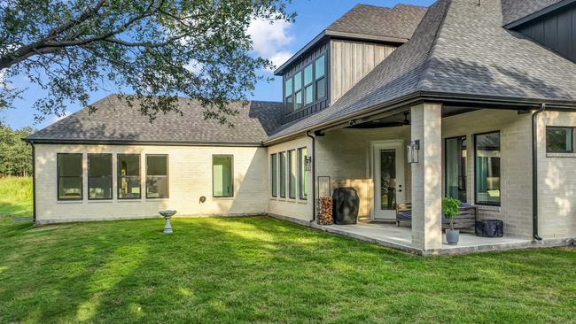 Rear view of property with roof with shingles, a yard, and a patio area | Image 34