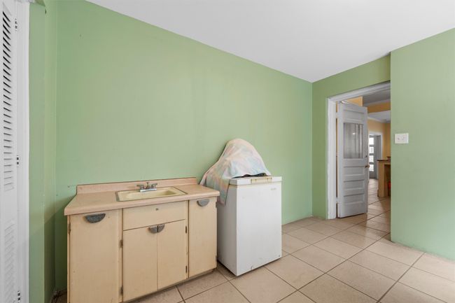 Kitchen featuring light tile patterned floors and light countertops | Image 12