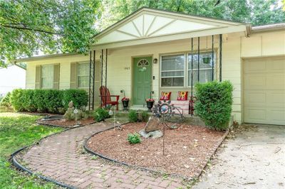 View of front of house featuring a garage and a porch | Image 1