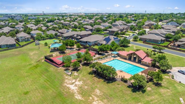 Aerial perspective of suburban area featuring a pool, playground and parks. | Image 38