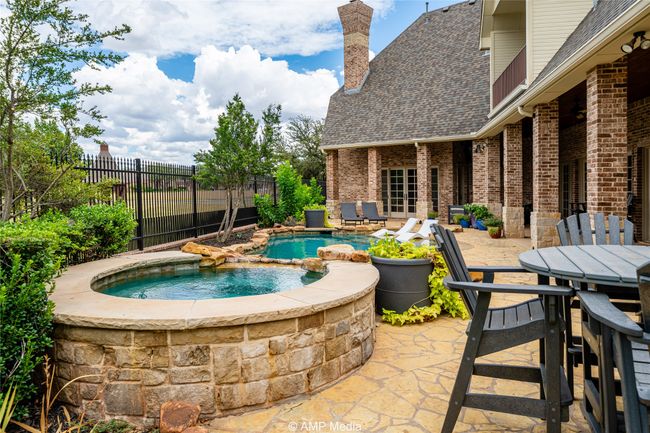 View of patio with a swimming pool with hot tub | Image 31