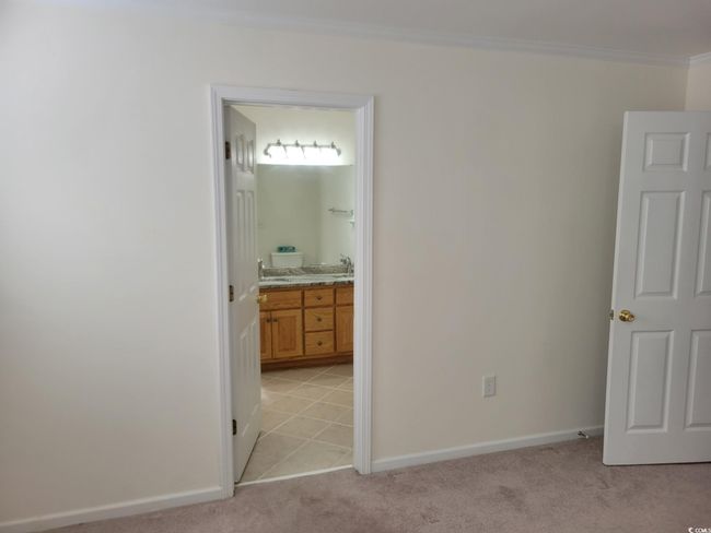 Unfurnished bedroom with ornamental molding, light carpet, and ensuite bathroom | Image 5