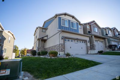 View of front facade featuring a front yard and a garage | Image 1